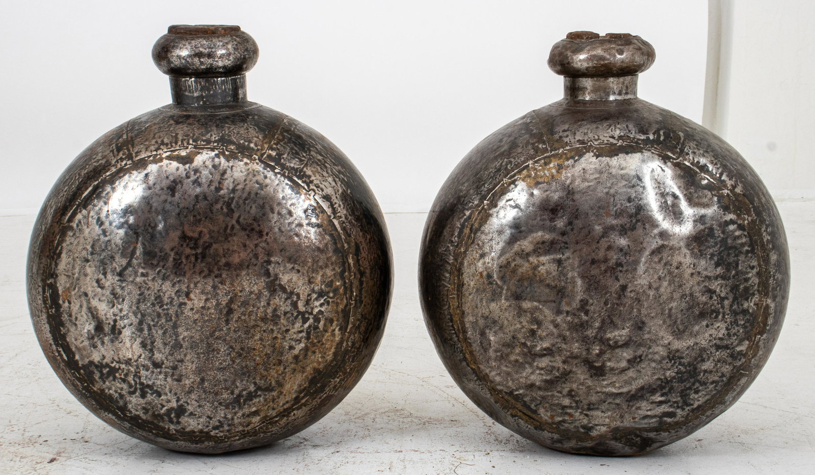 Mid-Century Modern Metal Floor Vases, Pair: Pair of Mid-Century Modern vintage patinated silver-tone metal floor vases with wooden corks, of moon flask form. 23" H x 20" W x 11" D. Provenance: Removed from an Englewood, NJ estate.