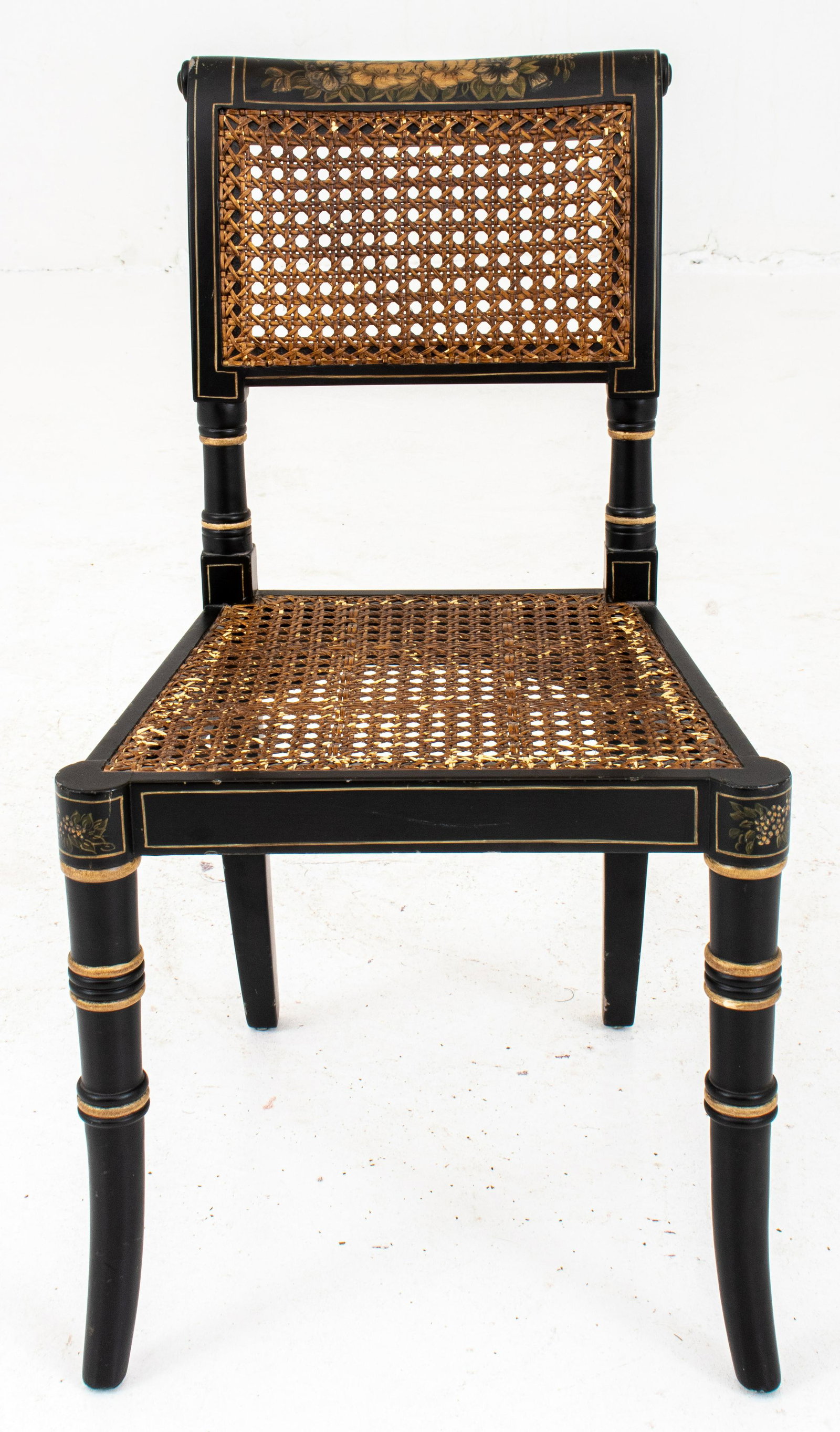 Sheraton Style Ebonized Wood & Cane Child's Chair: Sheraton manner ebonized wood and cane seat and back child's chair with gold-painted accents and hand-painted floral vignettes, "Chelsea House" plaque to underside.