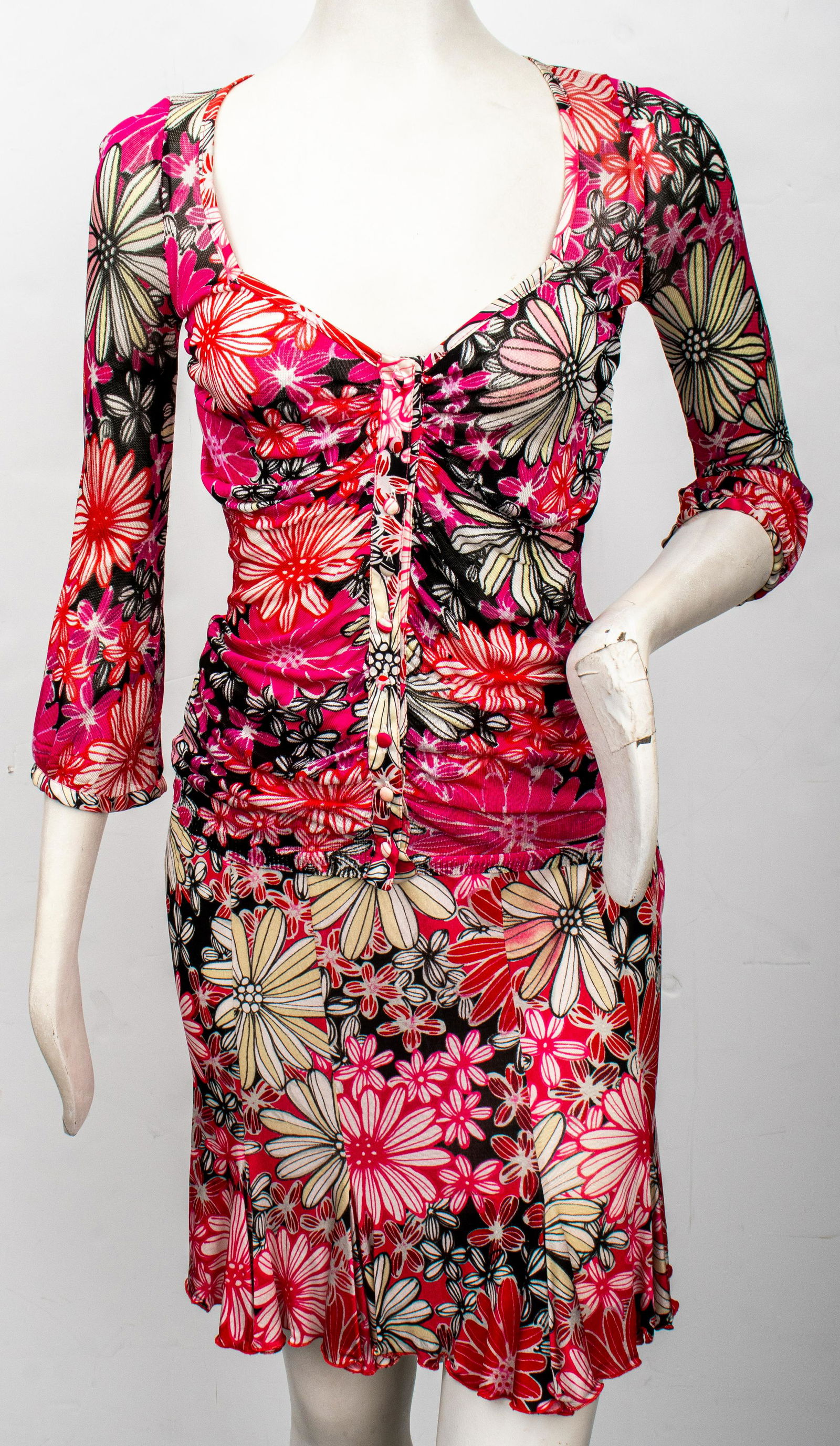 Blumarine Flower Knit Shirt & Skirt Set: Blumarine knit shirt and skirt set, in a colorful flower pattern, with silk details, made in Italy, no size label present. Shirt: shoulder: 12.25", bust: 32", waist: 23", hips: 27", length: 22.5", sle