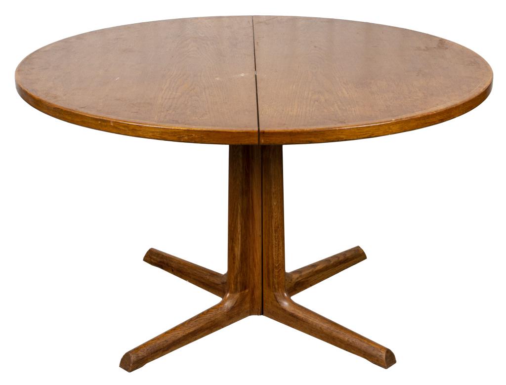 Modern Blonde Oak Dining Table (1 leaf): Modern blonde oak dining table, of round outline and with one leaf. 28.75” H x 48” diameter, leaf 19" W.