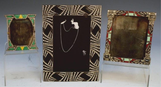 Lot of Three Art Deco Silver & Enamel Table Frames: Three silver, enamel and rhinestone table frames of varying sizes, one black, one red and green and one green and yellow, 1930s; marked. Dimensions: black 6-7/8"H x 5"W image area 5"H x 3-1/4"W; red a
