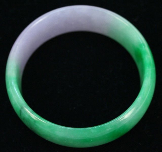 Chinese Translucent Green Jade Broad Bangle: Translucent green jade broad bangle, half apple green, China; unmarked. Dimensions: 7/8"H x 3-1/8" diameter