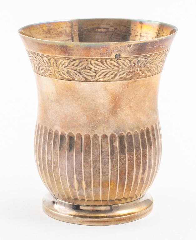 French 950 Silver Footed Beaker: A French 950 silver footed beaker with a band of foliate decoration and half the vessel ribbed. Marked near the rim. 3.5" H x 3" W. 3.21 ozt.