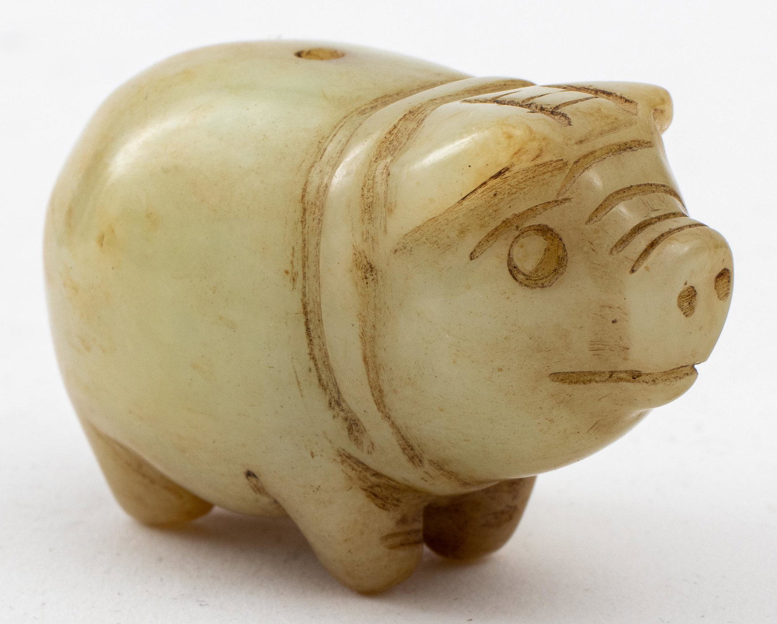 Japanese Carved Green Stone Pig Netsuke: Antique Japanese carved green hardstone netsuke in the form of a standing hog, the ojime with one hole for mounting. 1.25" H x 2" W x 1.25" D.