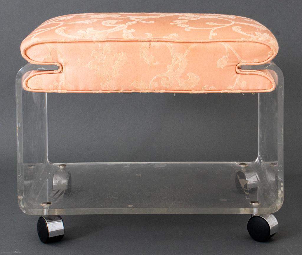 Charles Hollis Jones Satin & Lucite Ottoman: Charles Hollis Jones (American, b. 1945) pink satin and lucite ottoman on caster wheels, circa 1970s, unmarked. 16" H x 20.5" W x 18" D.
