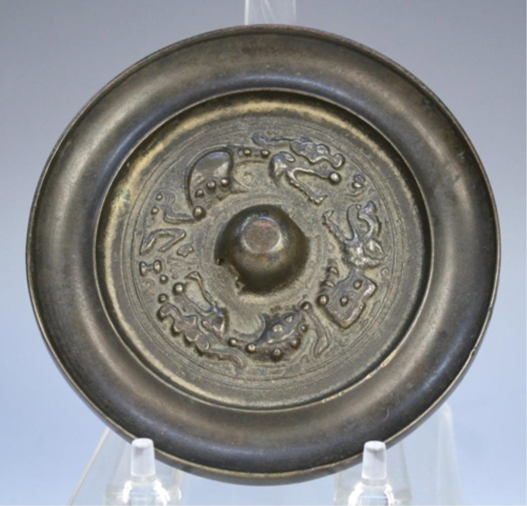 Chinese Bronze Mirror with Dragons: Small bronze mirror with dragon motif, China; marked. Dimensions: 4-7/8" diameter