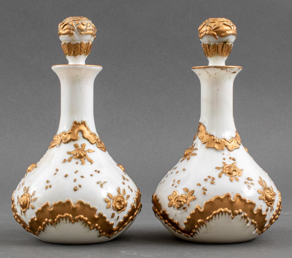 Gilt Opaque Opaline Glass Decanters, Pair: Pair of opaque opaline glass decanters cast with gilt roses and floral design. 10" H x 6" diameter.