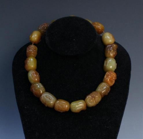 Carved Chinese Soapstone Prayer Beads: Carved soapstone prayer beads with brown tassel and facial carvings, China; unmarked. Dimensions: 15-1/2" (with tassel)