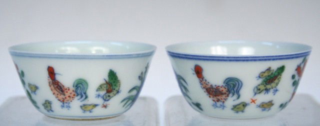 Chinese Doucai Porcelain Cup Pair Chenghua Mark: Pair of doucai eggshell porcelain cups decorated with flowers and roosters, China, Ming Dynasty (1368-1644 AD); Chenghua mark. Dimensions: each 1"H x 2-3/8" diameter