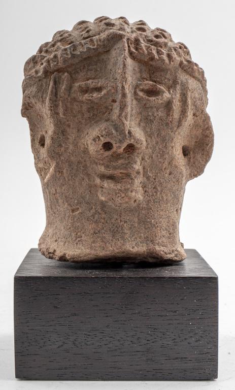 Terracotta Bust of a Woman: Terracottea bust of a female head, possibly Etruscan, upon a square hardwood base. 7" H x 3.75" W x 3.5" D.