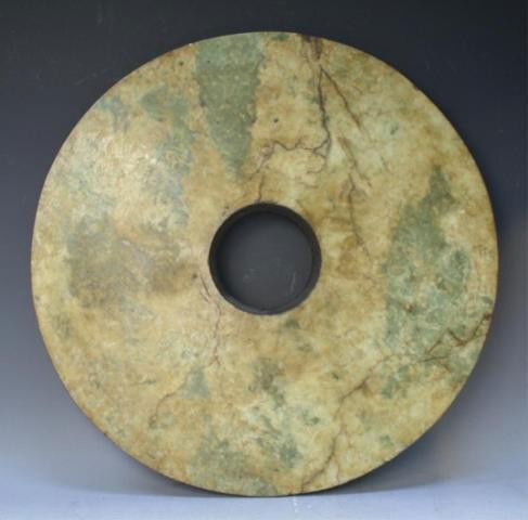 Chinese Large Qijia Culture Jade Bi: Large bi disk with brown and green color, jade, China, Qijia culture (2400 BC - 1900 BC); unmarked. Dimensions: 3/4"H x 20" diameter