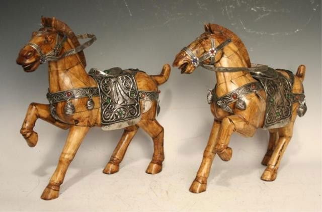 Pair of Ivory/Bone Horses with Metal Saddles: Pair of prancing horse sculptures with repousse saddles, ivory or bone and metal; unmarked. Dimensions: 13-1/4"H x 14-1/2"W x 4"D and 12-1/2"H x 14-1/2"W x 4"D
