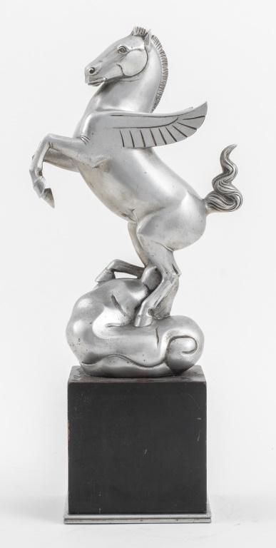 Art Deco Silver Tone Metal Pegasus Sculpture: Art Deco silver-tone metal sculpture depicting a winged horse Pegasus in flight upon a stylized cloud, mounted on an ebonized wood pedestal atop a metal base, struck with a "C" in a diamond and signed