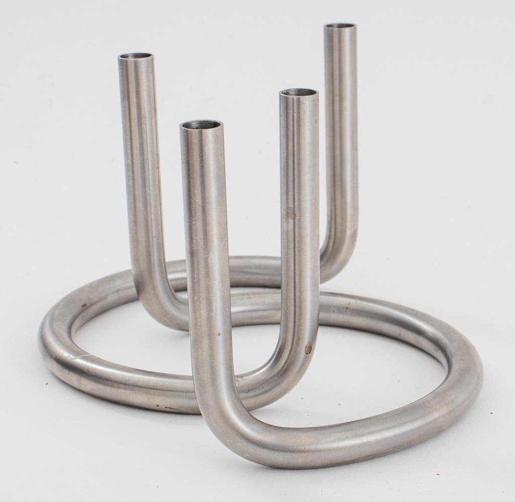 Peter Karpf Scandinavian 'Gemini' Candleholder, 2: Pair of Peter Karpf (Danish, born 1940) 'Gemini' stainless steel candleholders, each marked to bottom. 4.75" H x 6" W x 5" D.