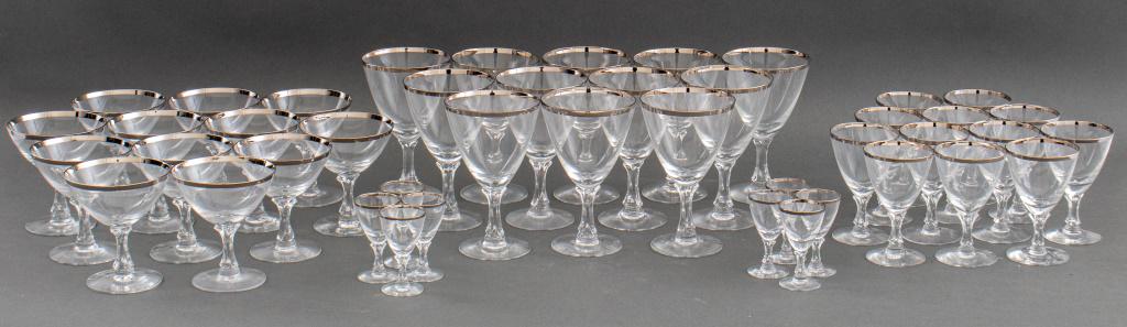 Fostoria Silver Edged Clear Glassware Service, 44: Set of forty four clear stemware service with silver edged by Fostoria comprising (12) coupe glasses, (12) water glasses, (12) wine glasses and (8) small liquor glasses, each engraved "Fostoria" to bo