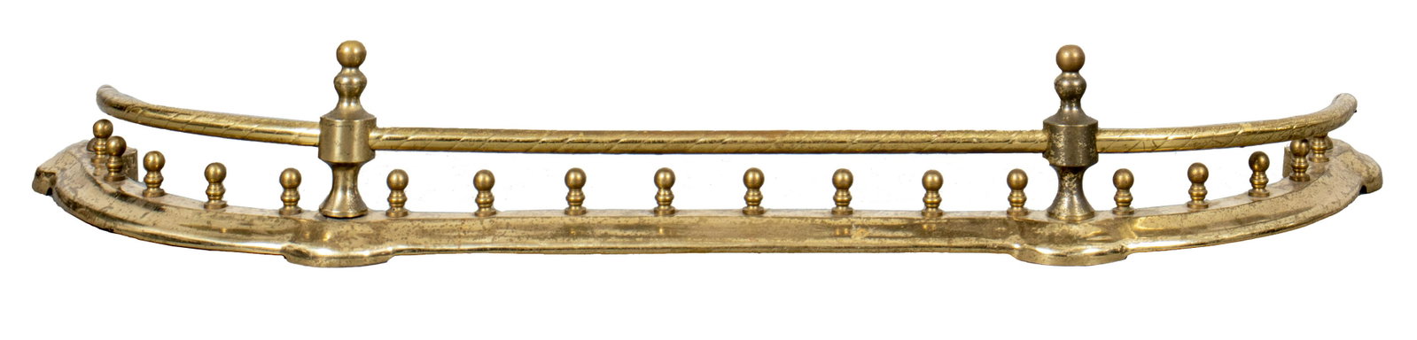 Brass Fender With Twisted Rail Motif: Brass fender of curved outline and with upper twisted rail. 6.5” H x 45” W x 13” D