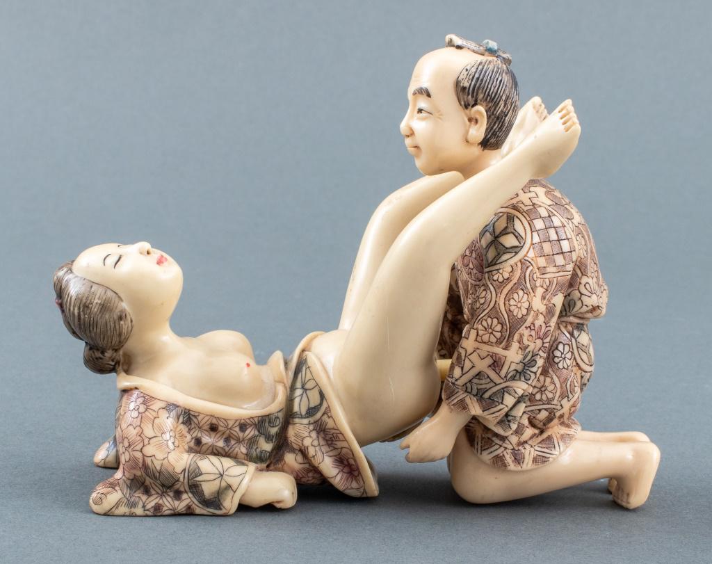 Japanese Erotic Resin Sculpture in 2 Pieces: Japanese erotica resin statue sculpture in two interlocking parts, one kneeling male figure and one female, both wearing robes, signed to inside of woman's robes. Man statue: 4.75" H x 2.75" W x 2.75"