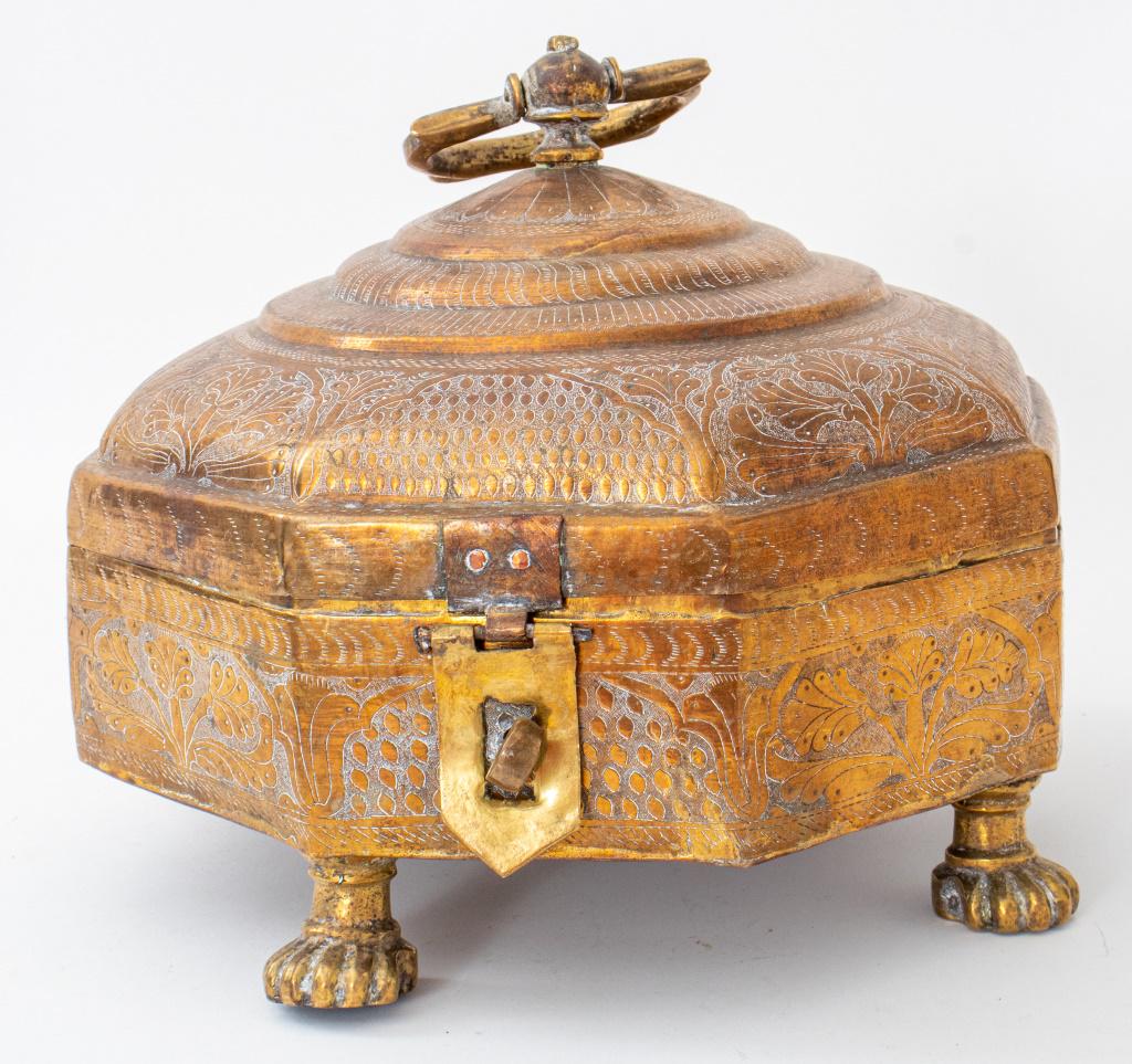 Indian Chased Brass Octagonal Box with Lid: Indian chased brass octagonal box and cover with handle enhance with floral motif raised on paw feet. 9.25" H x 10.5" W x 10.5" D.