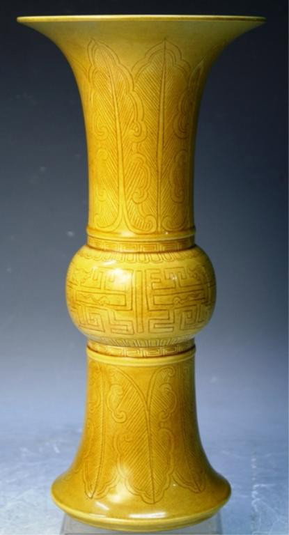 Chinese Yellow Porcelain Beaker Vase: Beaker vase with yellow glaze and incised decoration, porcelain, China; Guangxu mark on bottom. Dimensions: approximately 12-1/4"H x 5-3/4" diameter