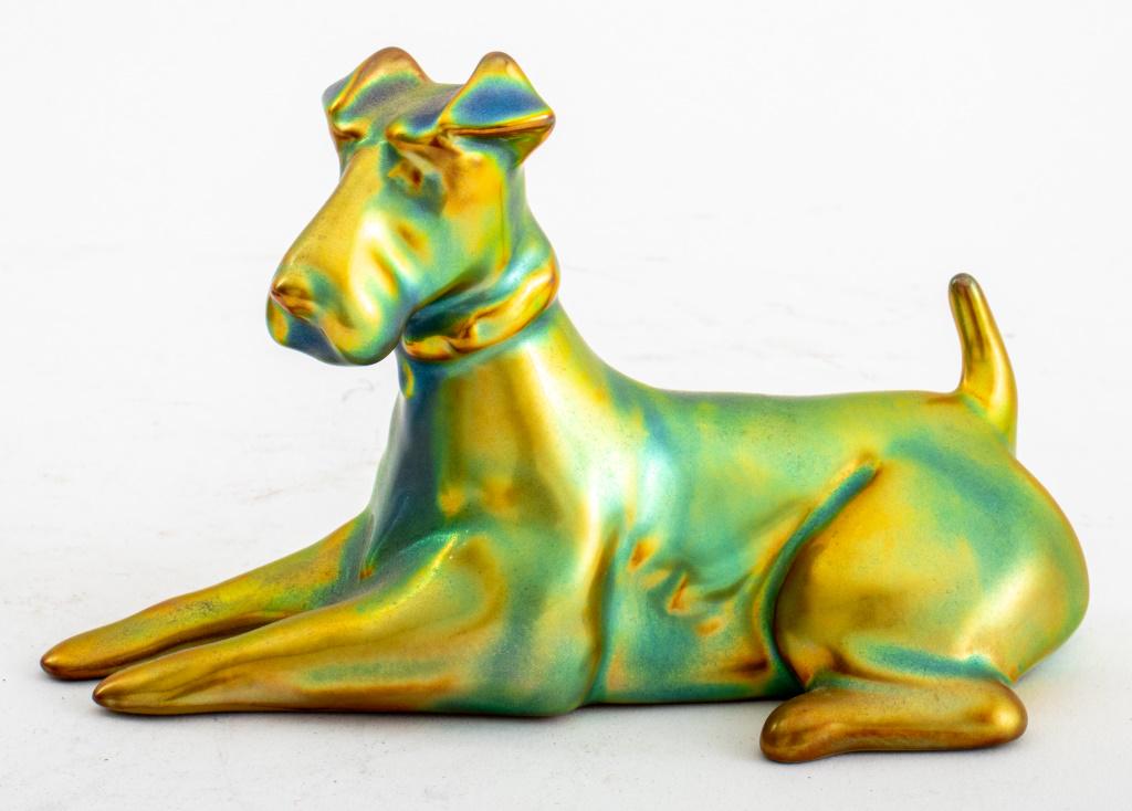Zsolnay Porcelain Figurine of a Fox Terrier Dog: Zsolnay iridescent porcelain figurine of a fox terrier, made in Hungary, marked. 3" H x 5" W x 2" D.