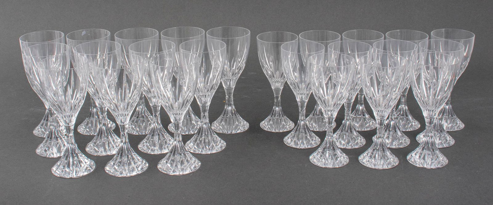 Christofle "Cathedrale" Crystal Cut Glassware, 24: Christofle 24 piece crystal cut stemware service in the "Cathedrale" pattern comprising (12) twelve wine glasses and (12) water goblets, each marked to underside. Tallest: 7.75" H x 3.25" diameter.