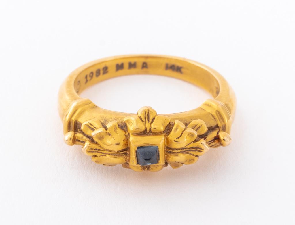 MMA 14K Neoclassical Reproduction Sapphire Ring: Metropolitan Museum of Art 14K yellow gold ring, polished, decorated in the Neoclassical style, featuring a centered bezel set cabochon blue sapphire, weighing approx.0.08 carat, marked: "(c) 1982 MMA