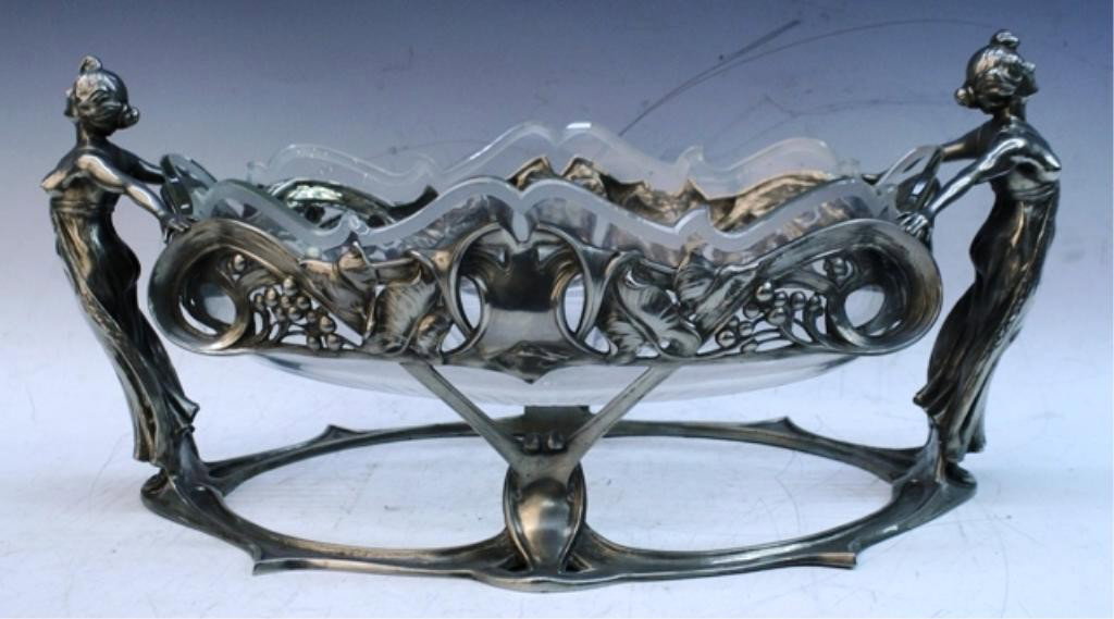 Large Glass & Metal Art Nouveau Centerpiece: Large glass and metal Art Nouveau centerpiece, handles are two female figures and base has berries and other scrolling designs; marked. Dimensions: 6-1/2"H x 18"W x 9"D