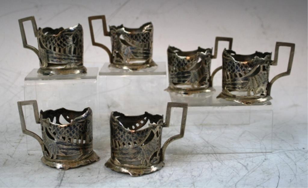 Set of 6 Silver & Niello Cup Holders: Set of six silver cup holders with niello accents and peacock/floral motifs; unmarked. Dimensions: each are 2-1/4"H x 3-1/4"W x 2-1/4" diameter weight: 15 oz