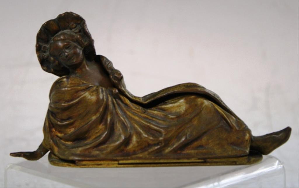 Jennings Bros. Bronze Figurine of Reclining Woman: Jennings Brothers figurine of reclining woman, hinge removes drapery to reveal semi nude body, bronze, United States, nineteenth to twentieth century; marked "JB 2039" on bottom. Dimensions: 3"H x 5-1
