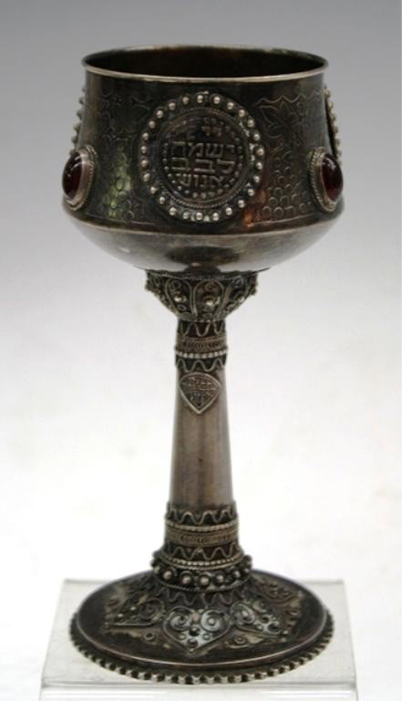 Bezalel Silver Wine Chalice w/ Filigree: Silver chalice with red stones, filigree work, and Hebrew script, engravings include grape leaves and the Tower of David in the form of medallions, Bezalel, Jerusalem; unmarked. Dimensions: 5-3/4"H x 