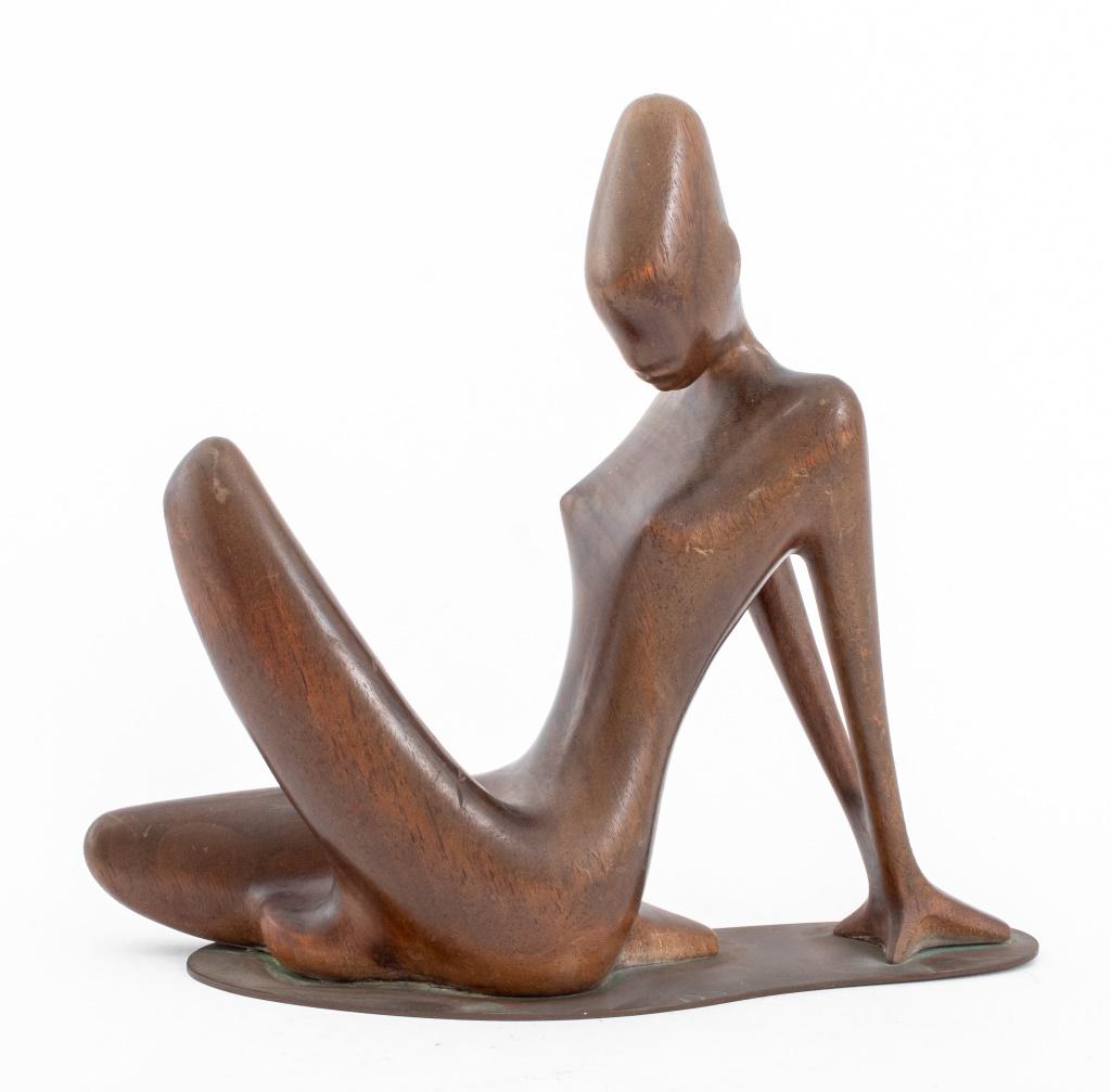 Karl Schmidt (Austrian, b. 1948) Werkstatte sculpture in wood depicting a reclining nude woman, atop: Karl Schmidt (Austrian, b. 1948) Werkstatte sculpture in wood depicting a reclining nude woman, atop a brass base, struck "MADE IN AUSTRIA / HANDMADE" with "KSW" maker's mark to underside. 9.5" H x 10