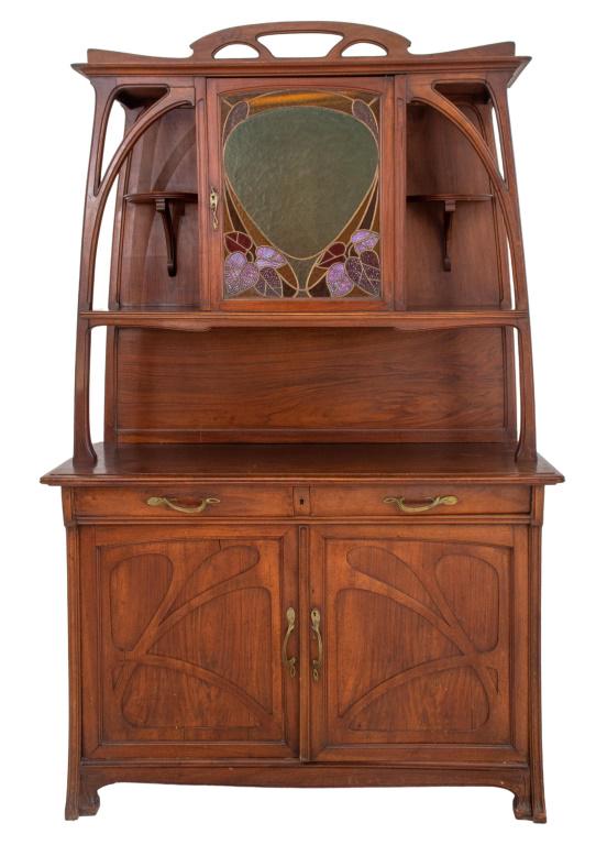 Liberty & Company attributed Art Nouveau mahogany and stained glass mounted buffet or server, circa: Liberty & Company attributed Art Nouveau mahogany and stained glass mounted buffet or server, circa 1890, the top with a pierced undulating cornice above a stained glass-fronted cabinet with leaded op