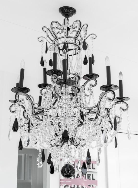 Baroque Revival black and colorless crystal chandelier with twelve candlestick form lights. 54" H x: Baroque Revival black and colorless crystal chandelier with twelve candlestick form lights. 54" H x 34" diameter.