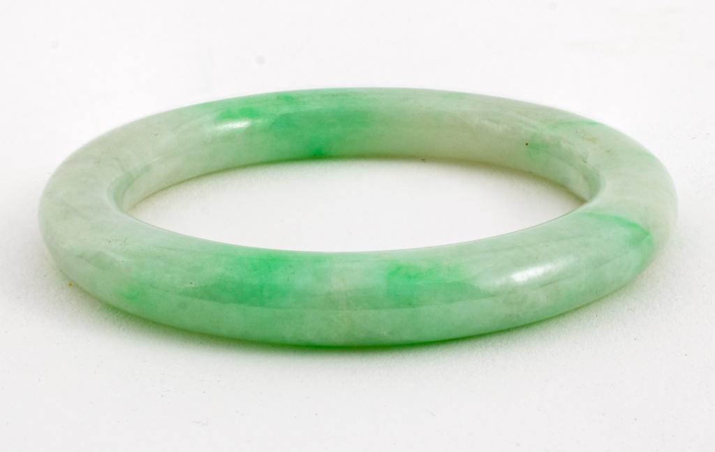 Chinese mottled white and emerald green jade small baby bangle. 2.25" diameter. Provenance: Property (1 of 4)