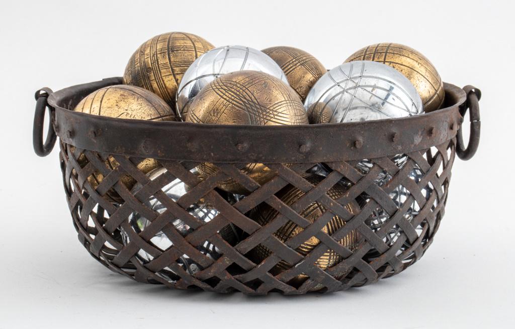 Assembled group of fourteen French petanque bowls presented in a metal woven basket used as (1 of 6)