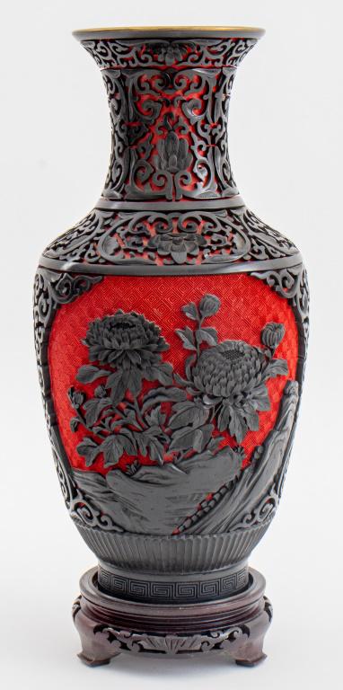 Chinese Cinnabar Resin Vase: Chinese vase decorated in cinnabar resin, inside and underside enameled, unmarked, on wooden base. 14" H x 6" diameter (with base); 12" H (without base).