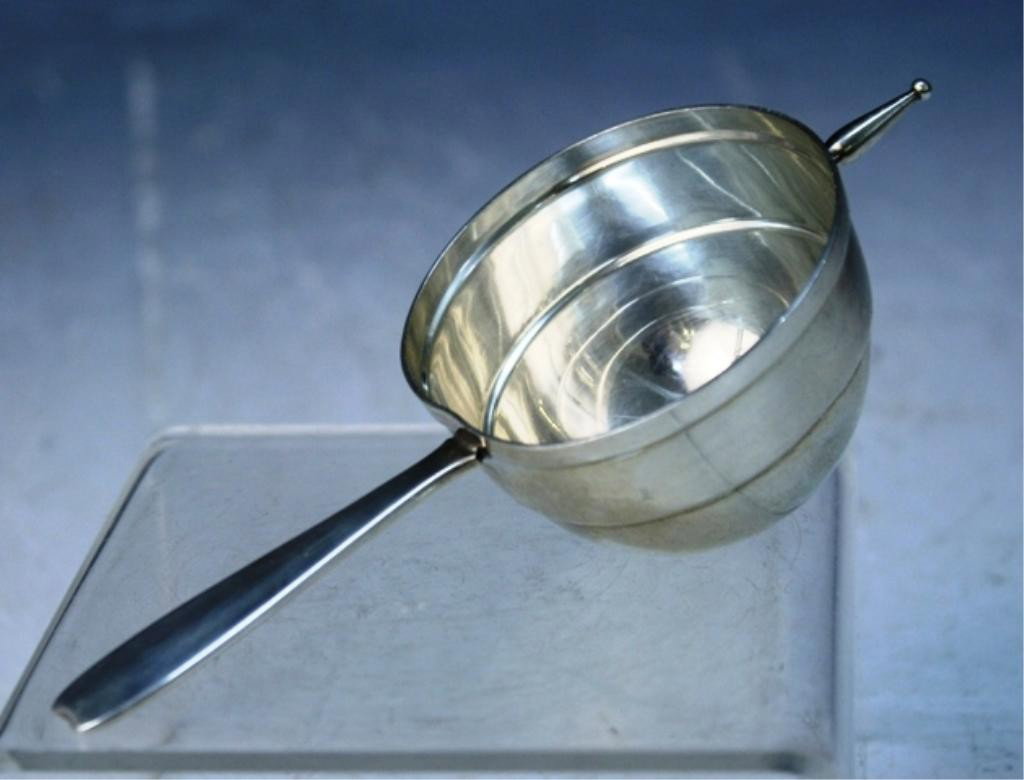 Tiffany & Co. Sterling Silver Measuring Cup: Small measuring cup with handle for liquids, Tiffany & Co., United States; marked on handle. Dimensions: 1-1/2"H x 5-1/2"L x 2-1/4" diameter Weight: 2 oz.