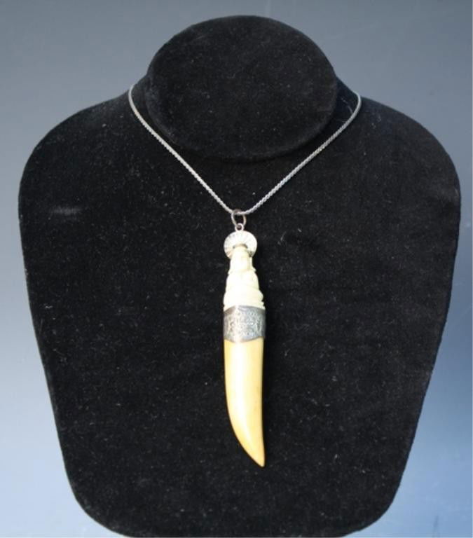 Chinese Ivory Pendant with Buddha: Carved Buddha pendant with knife point and stamped metal accents and silver chain, Ivory pendant and sterling silver chain, China; chain clasp marked 925 and MADE ITALY. Dimensions: necklace with pend