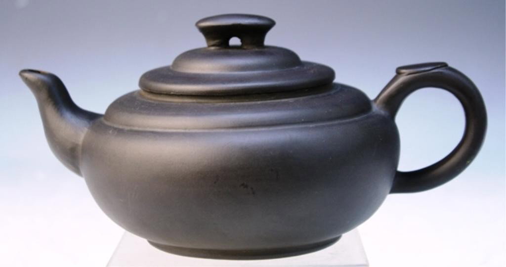 Chinese Yixing Teapot: Dark brown Yixing teapot, China; Marked. Dimensions: 31/2"H x 7 3/4" W x 5"D