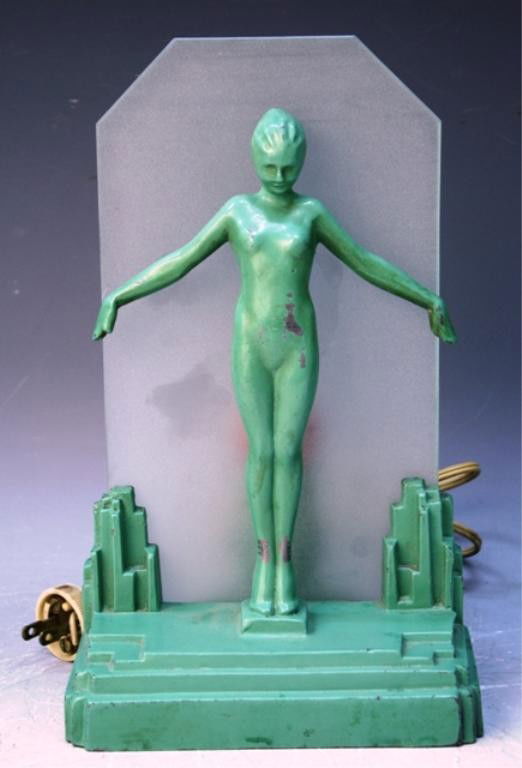 Frankart Art Deco Silhouette Nude Lamp: Frankart art deco silhouette nude lamp in green enamel covered metal with a frosted glass background, United States, ca. 1920s/30s; marked. Dimensions: 10-3/4"H x 6-1/2"W x 5"D