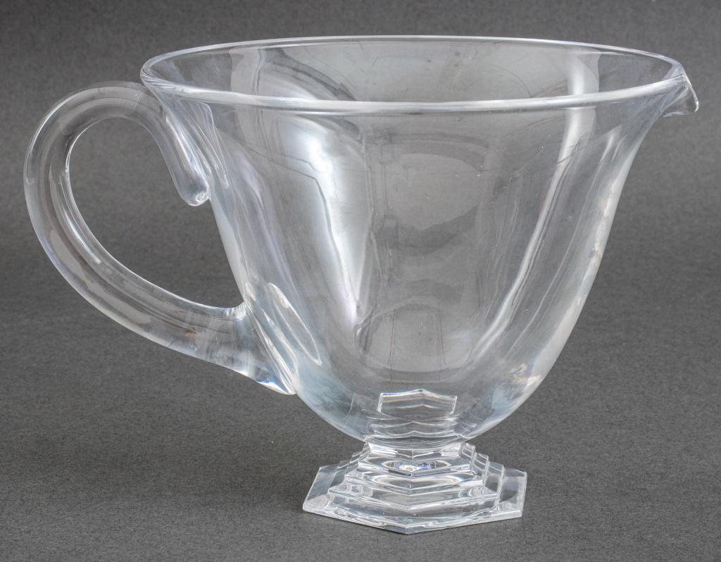 Baccarat "Orsay" Crystal Footed Carafe with Handle: Baccarat crystal footed carafe with handle or large creamer in the "Orsay" pattern, etched "Baccarat France" to underside. 5.5" H x 8" W x 6.5" D.