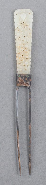 Chinese Carved Jade Silver Hair Pin: Chinese carved jadeite hair pin with silver prongs, the plaque decorated with flowers surmounted by a butterfly. Weight: 15 g (inclusive); 6.75" L x 0.75" W. Provenance: Property from the Manhattan es