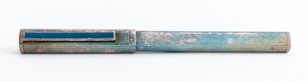 Dunhill Vintage Silvered Metal Fountain Pen: Dunhill fluted silvered metal fountain pen with blue lacquered accent and logo, Germany, having 18K Gold nib. 5.5" H x 0.5" Diameter.