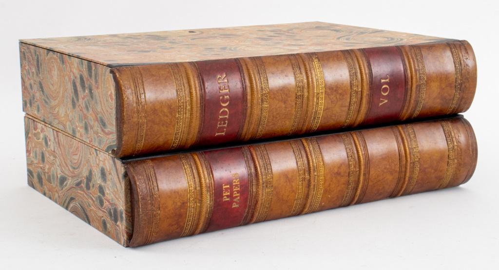 Leather Bounded Faux-Book Folder, 2: Group of two folder with gilt decorated brown leather bounded faux-book edges. Each: approx. 14.5" H x 10.5" W x 3.25" D.
