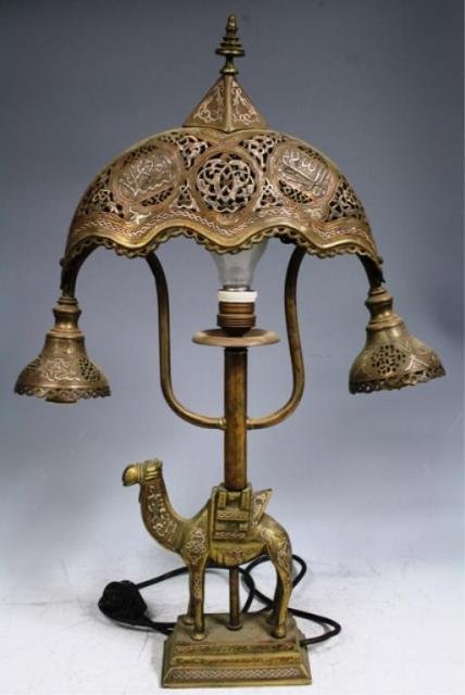 Middle Eastern Engraved Brass Lamp with Camel: Engraved table lamp with camel, brass, possibly Persia or Turkey; unmarked. Dimensions: 24-1/2"H x 16-1/2"W x 3-1/2"D
