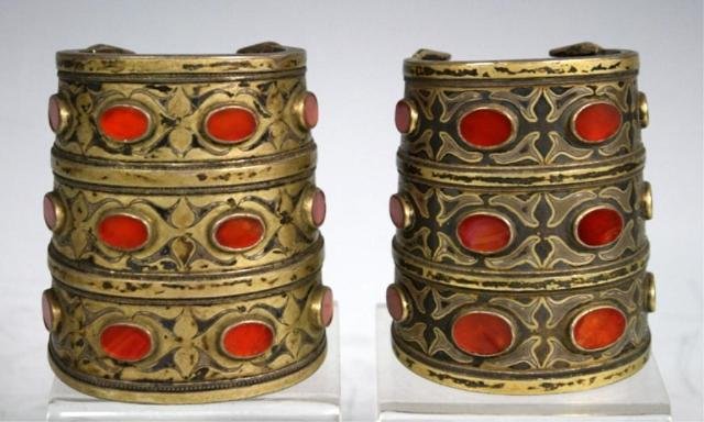 2 Turkoman Cuff Bracelets w/ Carnelian Inlays: Lot of two fire-gilded silver Turkoman cuff bracelets with Carnelian inlays, Central Asia, nineteenth to twentieth century; unmarked. Dimensions: 3-3/8"H x 3" diameter; 3-1/2"H x 3" diameter