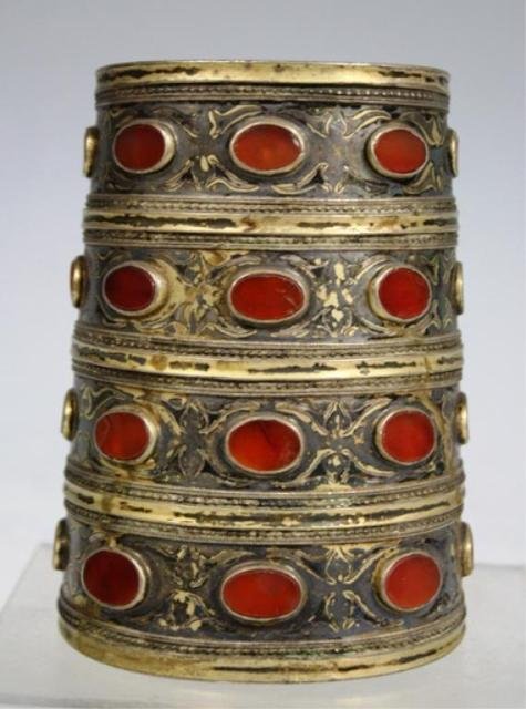 Turkoman Cuff Bracelet w/ Carnelian Inlays 20th C.: Fire gilded silver Turkoman cuff bracelet with Carnelian inlays, Central Asia, nineteenth to twentieth century; unmarked. Dimensions: 4"H x 3" diameter