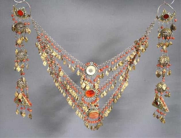 Turkoman Gilded Silver Chest Ornament: Fire-gilded silver chest ornament with turquoise, carnelian, mother of pearl, coral and agate inlays, possibly Uzbekistan; unmarked. Dimensions: 20"W x 12"L