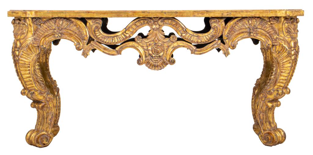 Georgian Revival Carved Giltwood Center Table: Georgian revival heavy carved giltwood console or center table with four carved sides and gilt wood top, the legs in carved acanthus scrolled shape. 31" H x 66" W x 24" D.