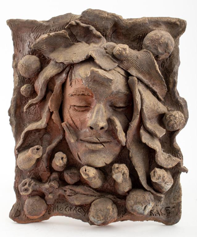 Louis Mendez "Democracy" Unglazed Ceramic: Louis Mendez (American, 1929-2012) "Democracy" a sculptural panel in unglazed ceramic, showing a serene female face engulfed in unspeakable horrors, inscribed "Democracy" lower left, and initialed "L.